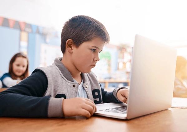 Student using laptop in classroom